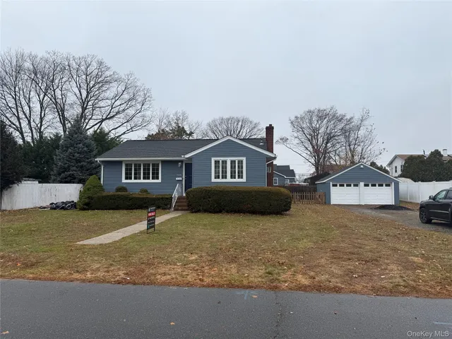 a front view of a house with a yard covered in snow