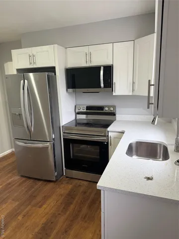 a kitchen with a refrigerator sink and microwave