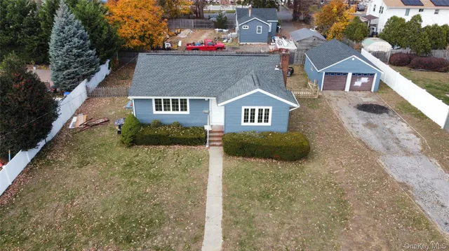 a view of a house with a yard and garage