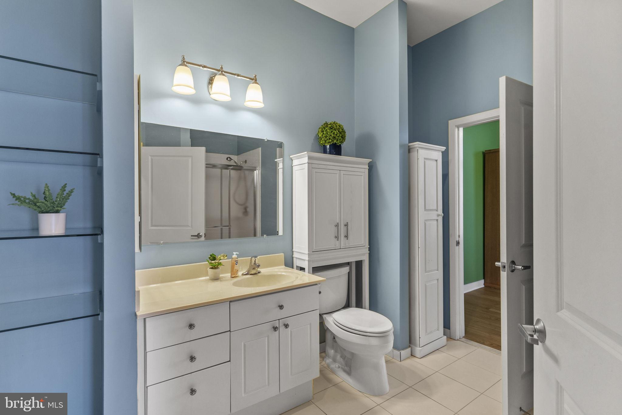 181 East Reed Avenue, Unit 411 Alexandria, VA 22305 - Photo 18 of 24 a bathroom with a double vanity sink toilet and shower