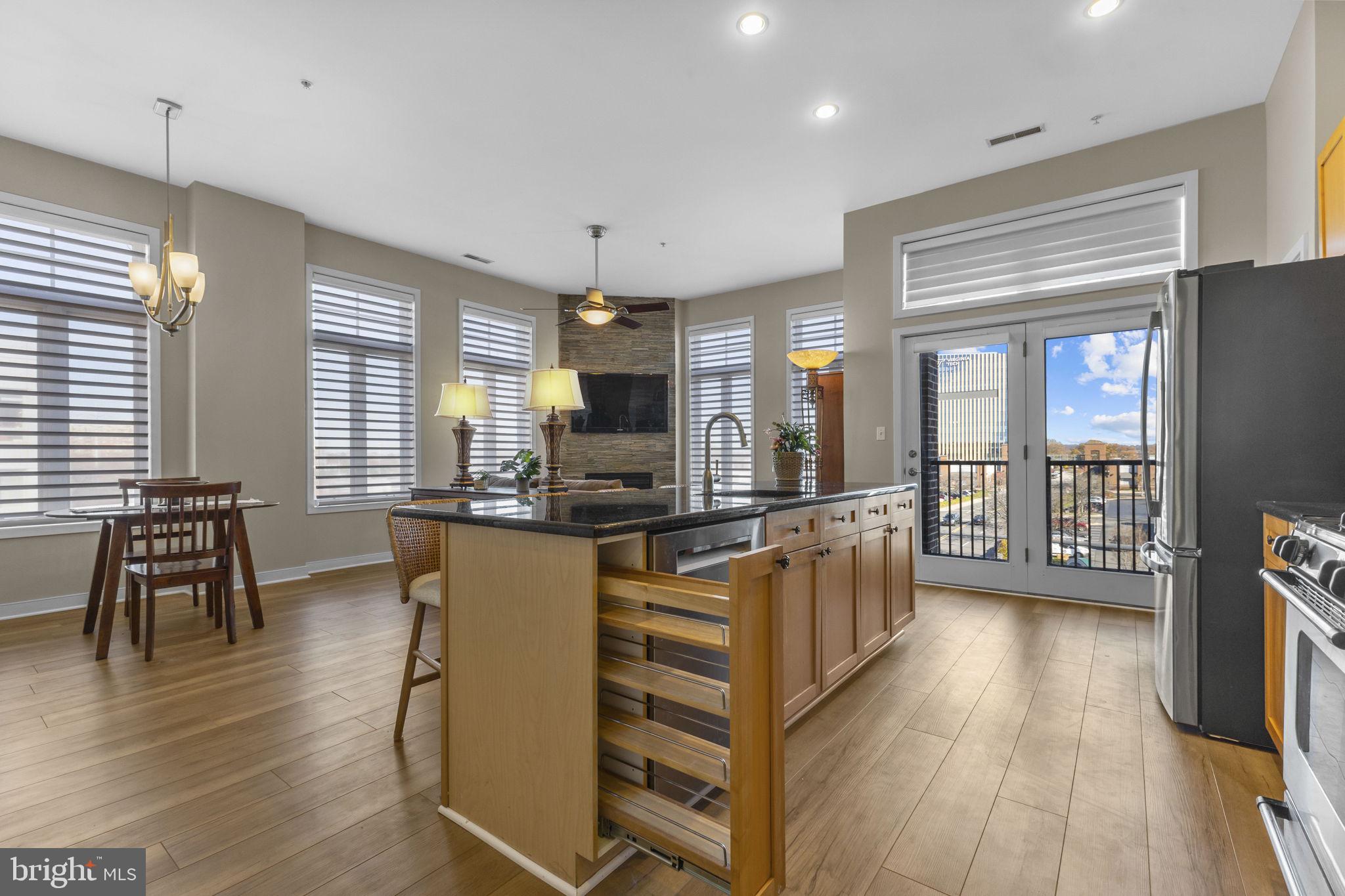 181 East Reed Avenue, Unit 411 Alexandria, VA 22305 - Photo 4 of 24 a kitchen with counter top space wooden floor and appliances