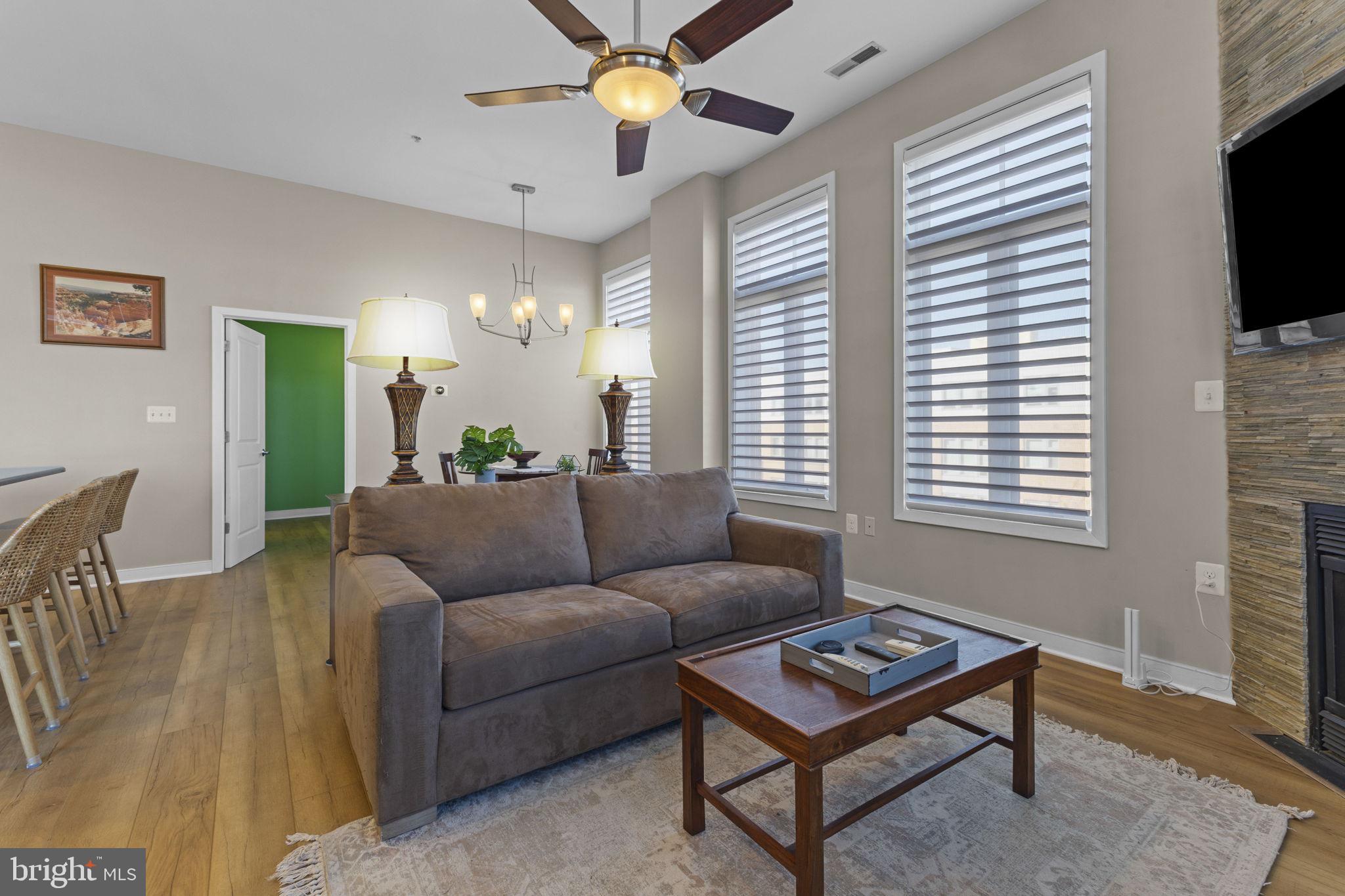 181 East Reed Avenue, Unit 411 Alexandria, VA 22305 - Photo 9 of 24 a living room with furniture a flat screen tv and a window