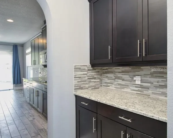 a view of a kitchen cabinets and wooden floor