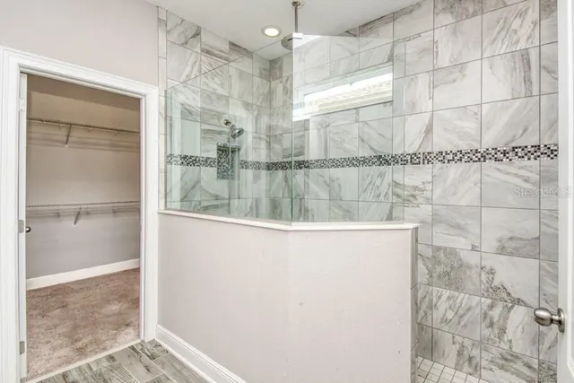 a bathroom with a glass shower door
