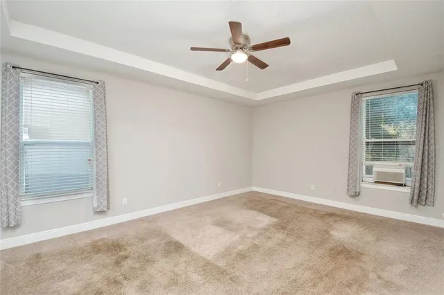 an empty room with closet and windows