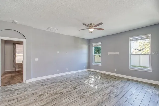 wooden floor in an empty room with a window