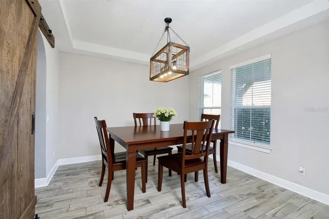 a view of a dining room with furniture window and wooden floor