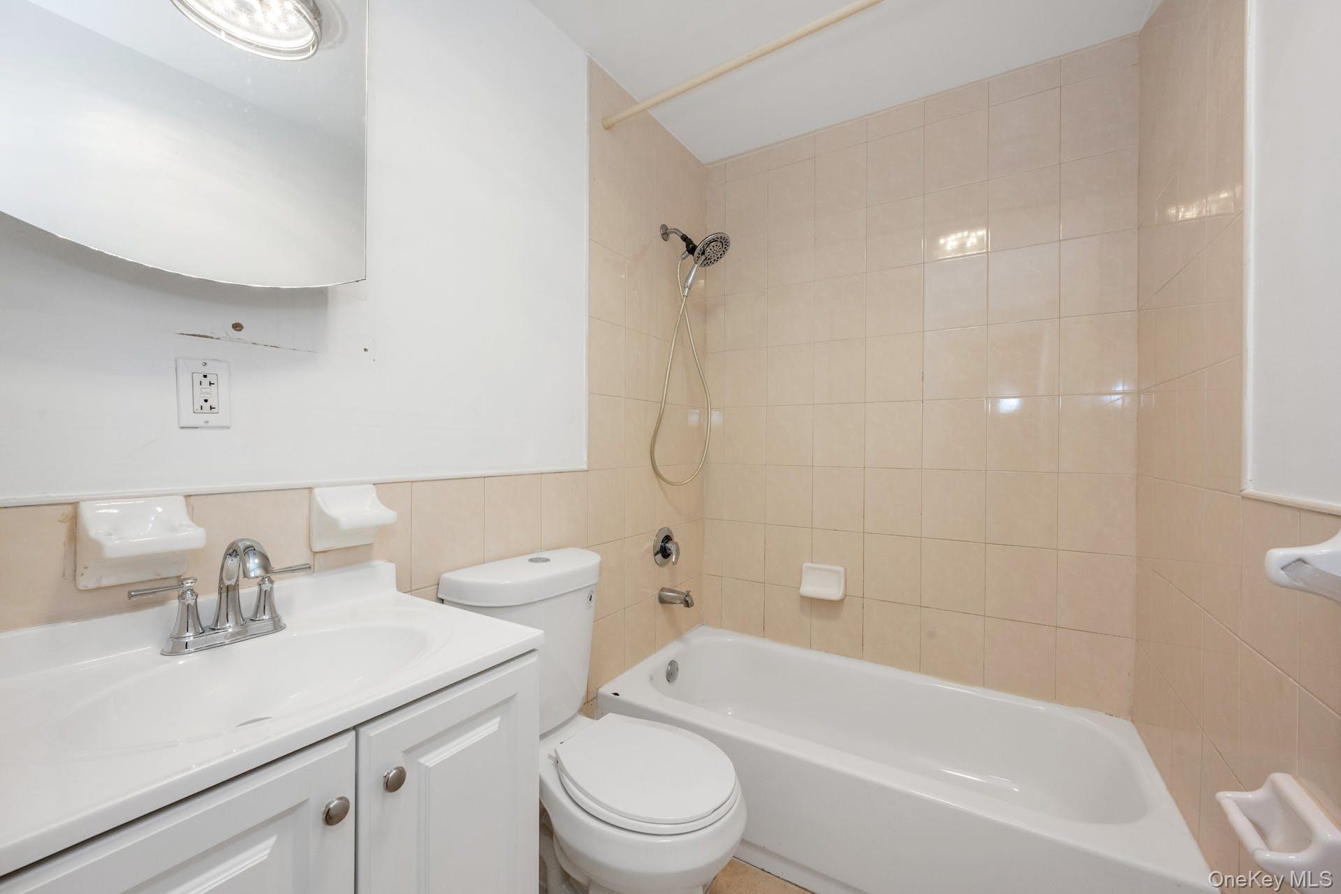 3313 Rombouts Avenue Bronx, NY 10475 - Photo 16 of 44 a bathroom with a sink a toilet and shower