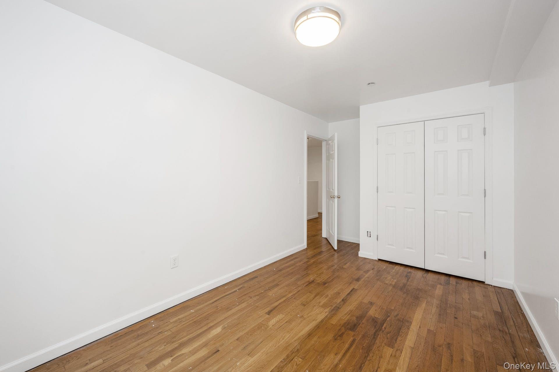 3313 Rombouts Avenue Bronx, NY 10475 - Photo 18 of 44 a view of an empty room with wooden floor