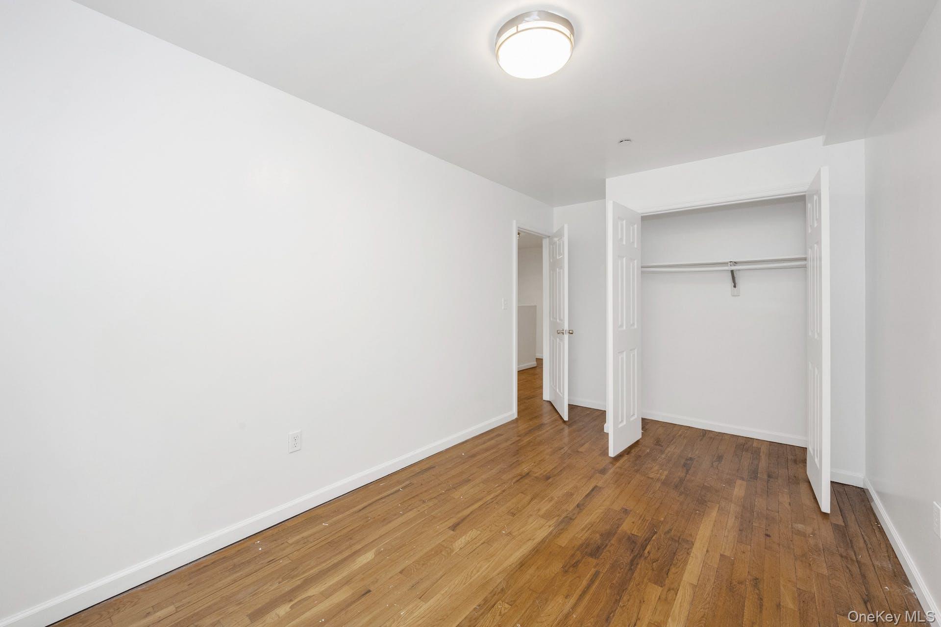 3313 Rombouts Avenue Bronx, NY 10475 - Photo 19 of 44 a view of an empty room with wooden floor