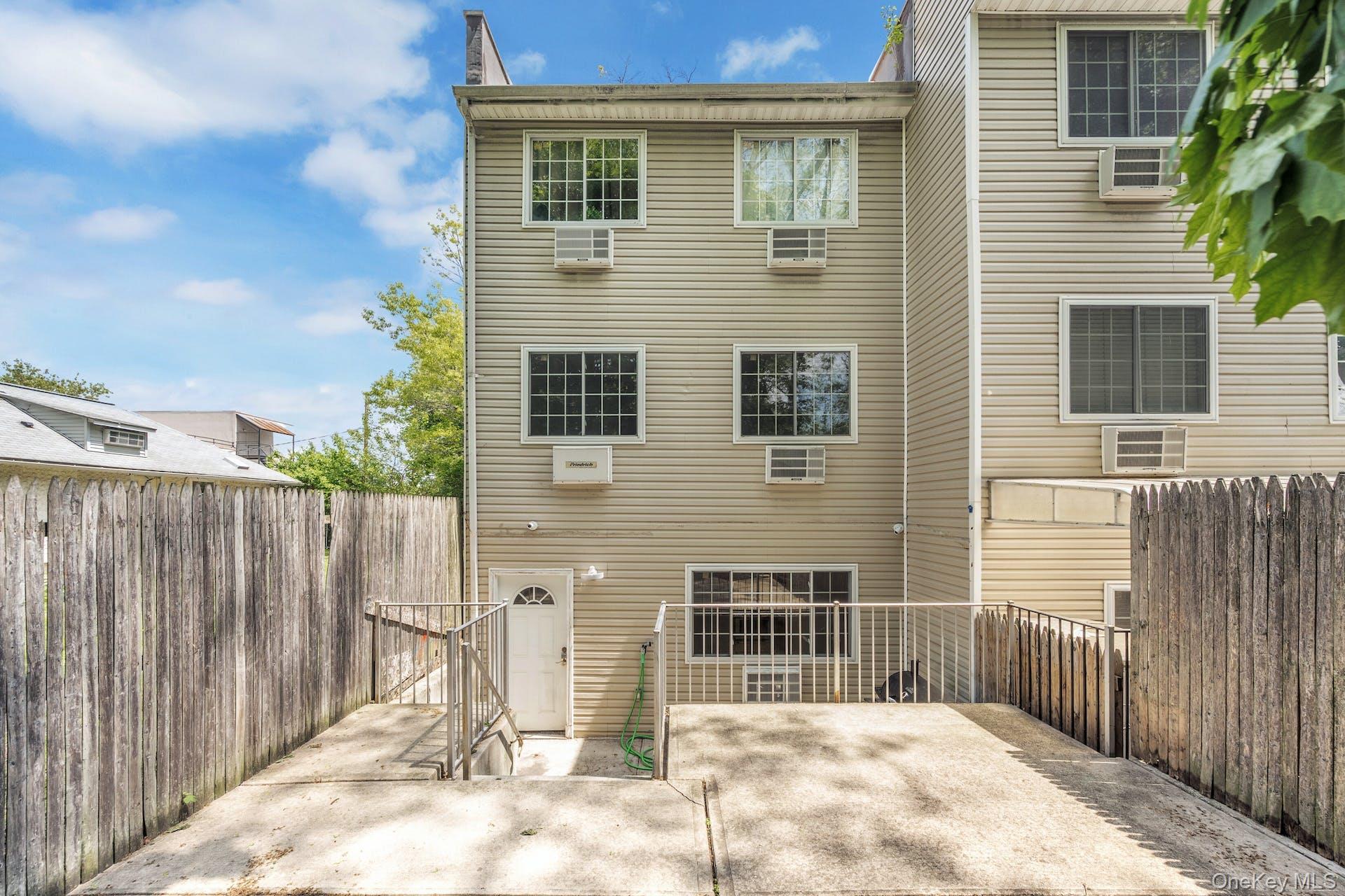 3313 Rombouts Avenue Bronx, NY 10475 - Photo 32 of 44 a front view of a house with a fence
