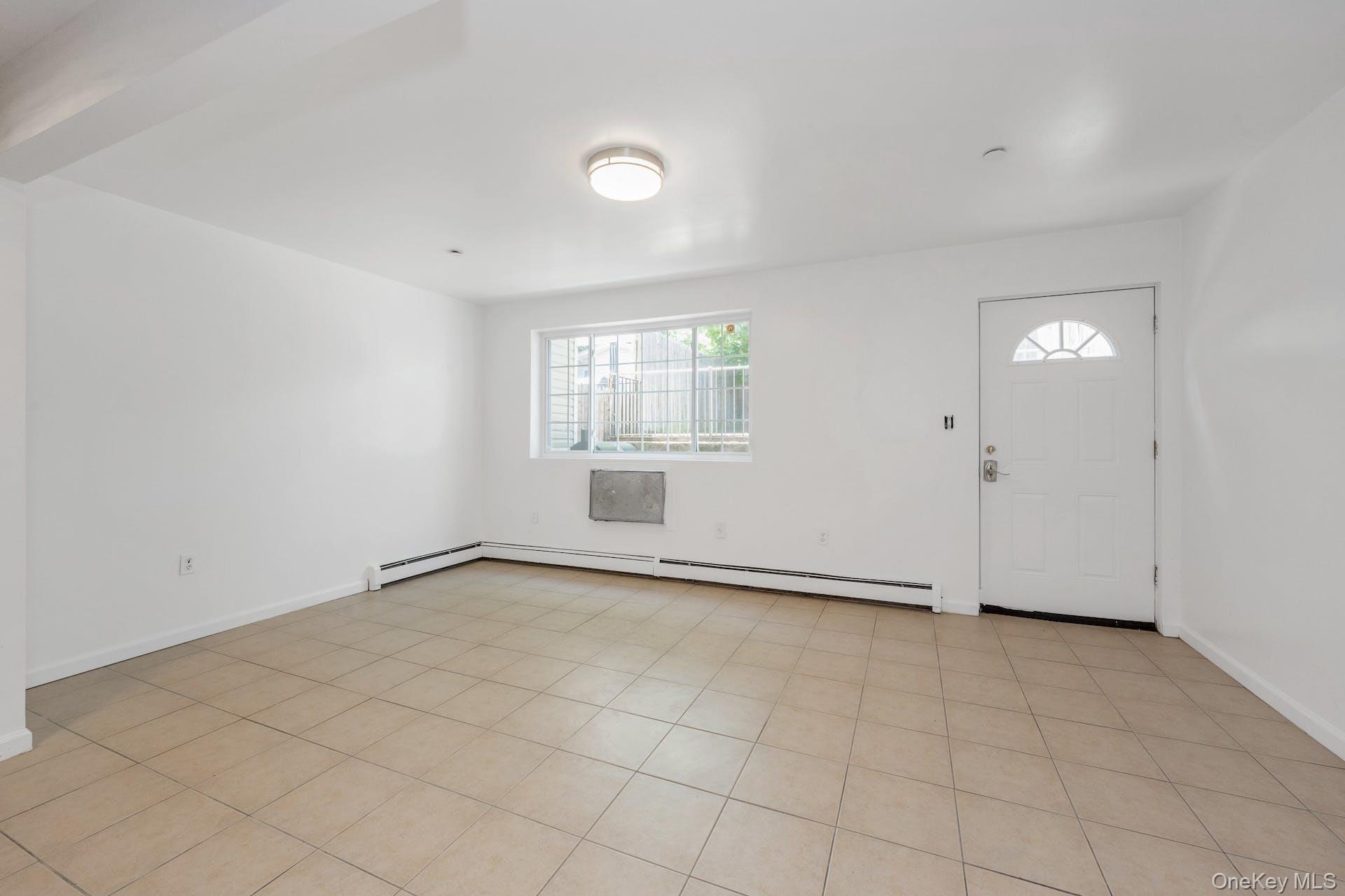 3313 Rombouts Avenue Bronx, NY 10475 - Photo 4 of 44 an empty room with windows and closet