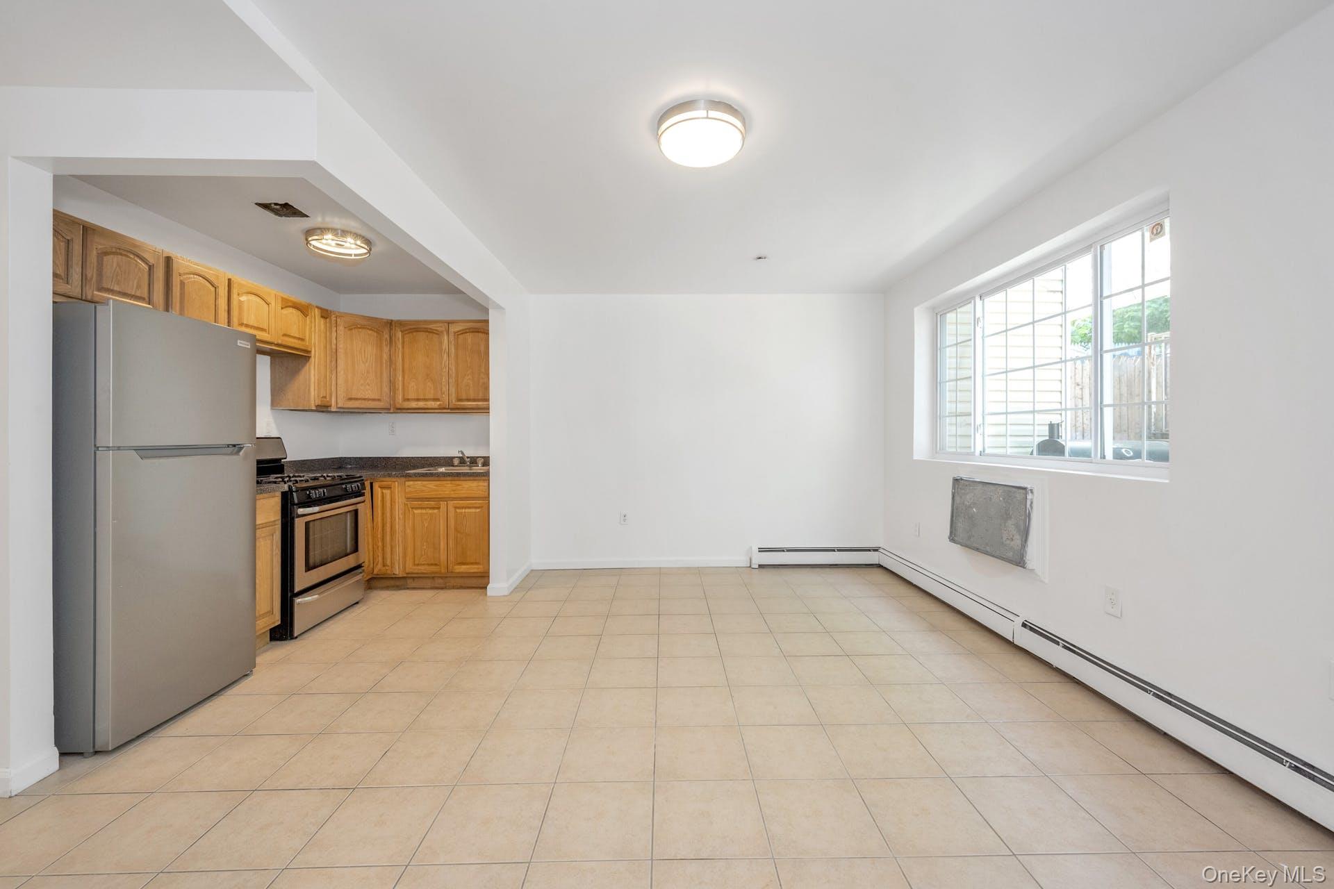 3313 Rombouts Avenue Bronx, NY 10475 - Photo 8 of 44 a view of a kitchen with a sink stove refrigerator and cabinets