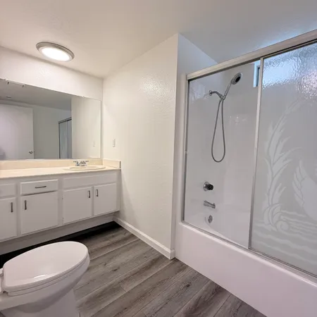 a bathroom with a sink toilet and shower