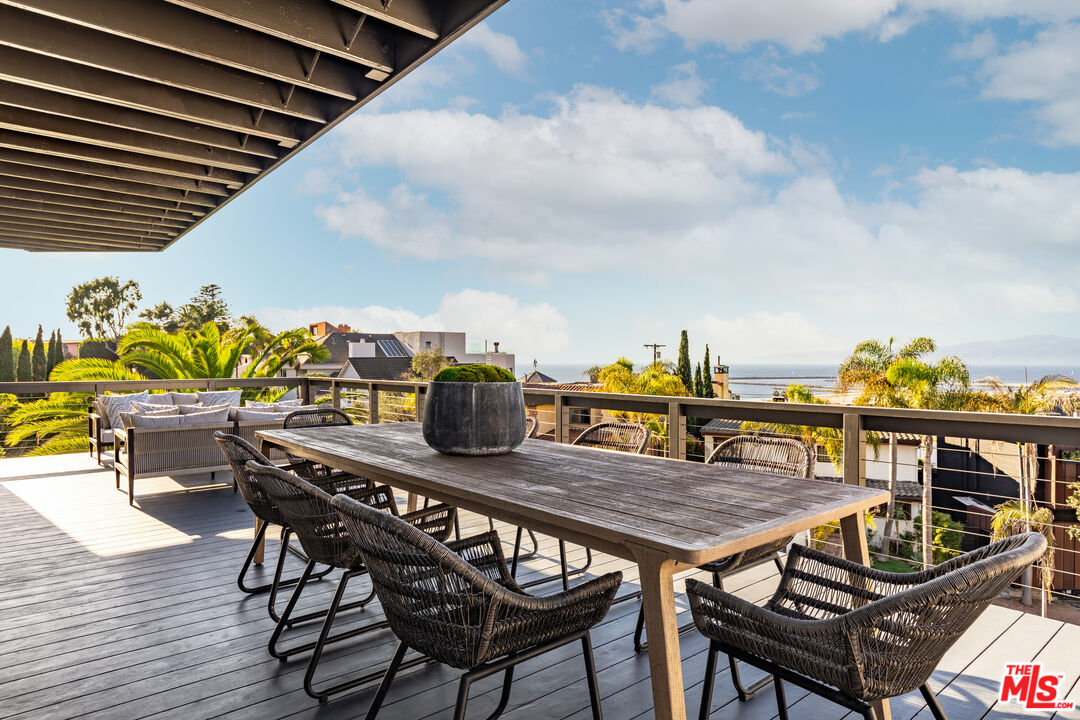 249 Rees Street Playa del Rey, CA 90293 - Photo 11 of 37 a roof deck with a dining table and chairs with wooden floor