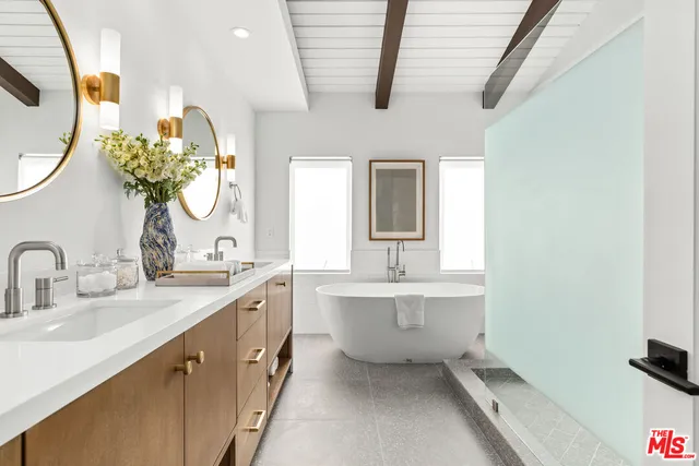 a spacious bathroom with a double vanity sink and a mirror