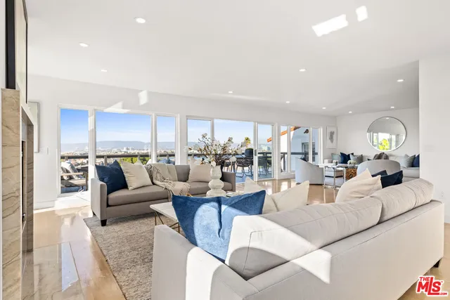 a living room with lots of furniture and view of kitchen