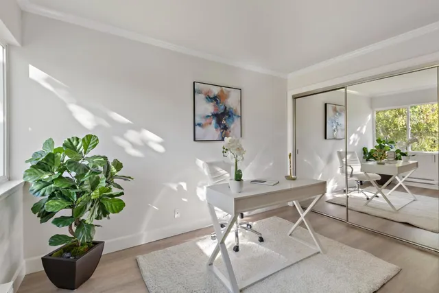 a bathroom with a granite countertop sink a toilet and a mirror