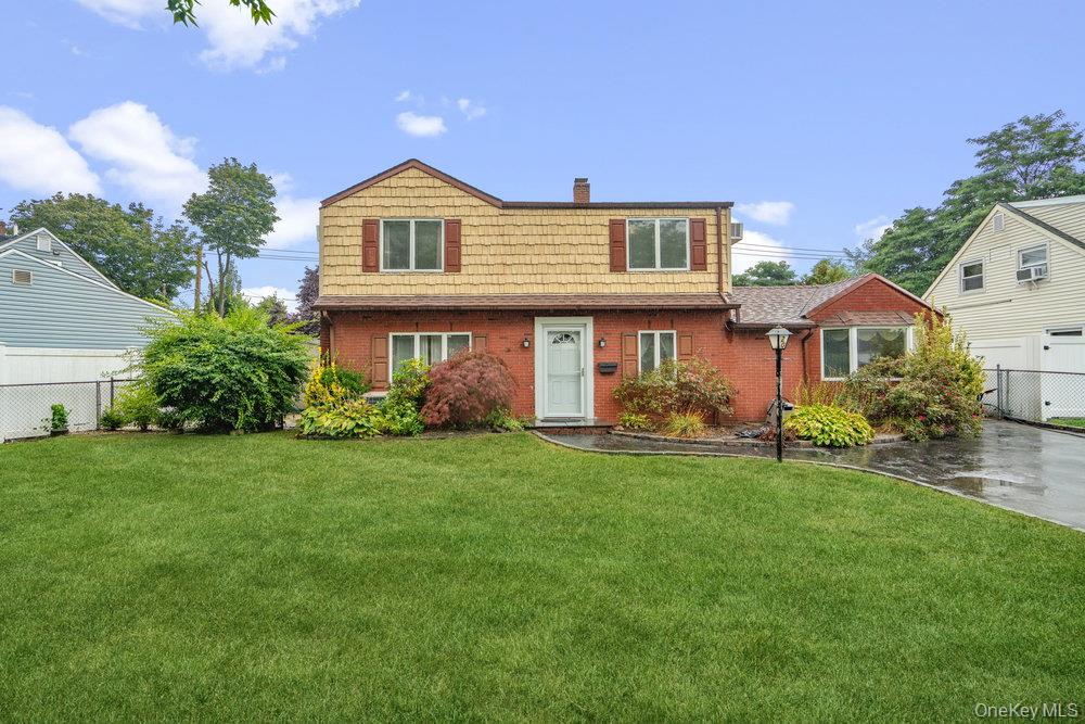 20 Carnation Road Levittown, NY 11756 - Photo 1 of 1 View of front facade featuring a chimney and brick siding