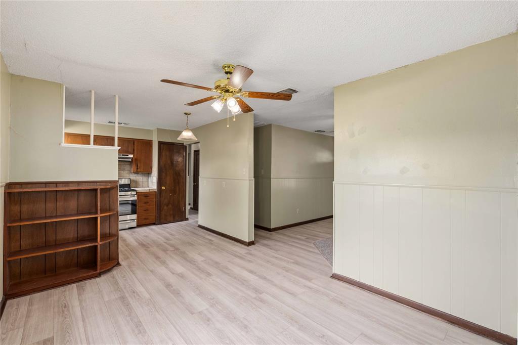 900 West 2nd Street Coleman, TX 76834 - Photo 11 of 28 a view of a room with wooden floor and a ceiling fan