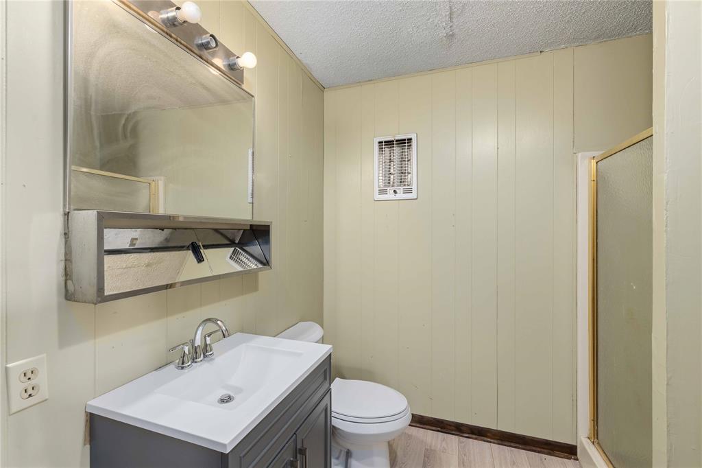 900 West 2nd Street Coleman, TX 76834 - Photo 13 of 28 a bathroom with a sink mirror and toilet