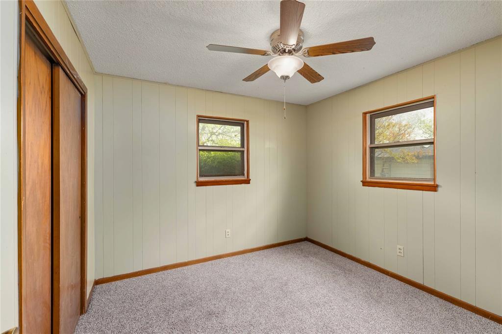 900 West 2nd Street Coleman, TX 76834 - Photo 14 of 28 an empty room with windows and fan