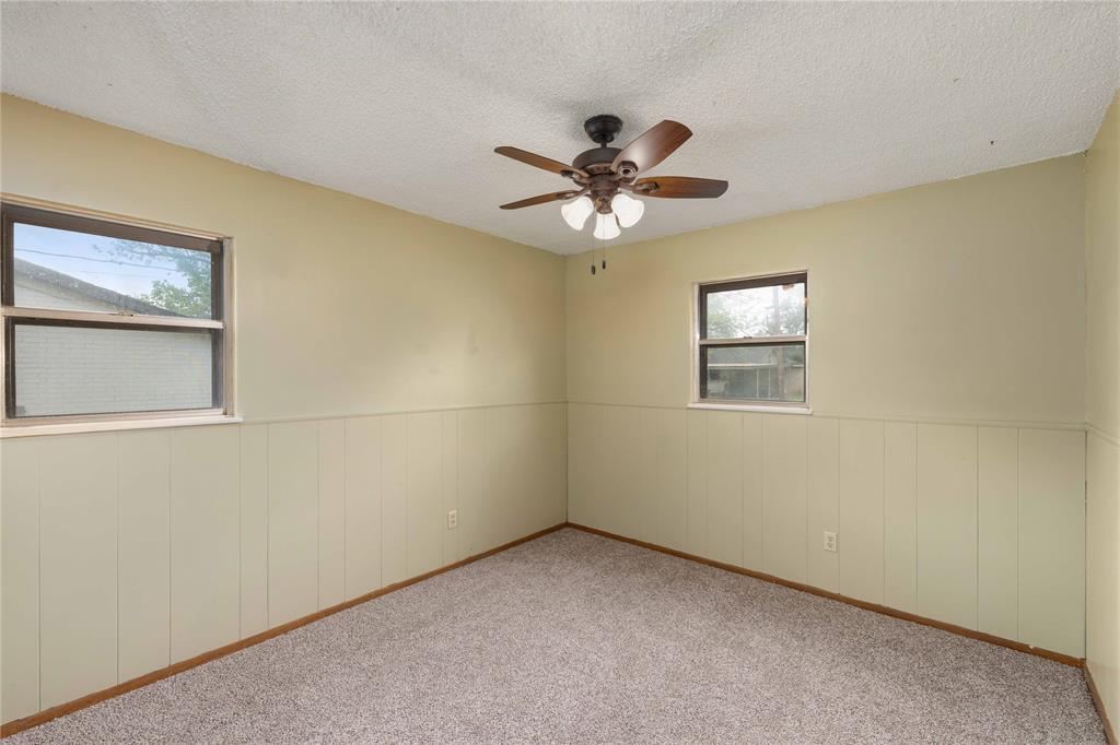 900 West 2nd Street Coleman, TX 76834 - Photo 17 of 28 an empty room with a window and a fan