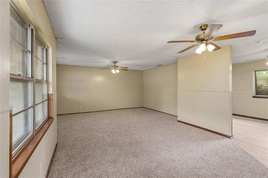 900 West 2nd Street Coleman, TX 76834 - Photo 5 of 28 a view of an empty room with a ceiling fan and window