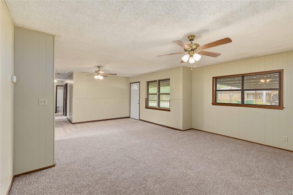 900 West 2nd Street Coleman, TX 76834 - Photo 7 of 28 an empty room with windows and fan