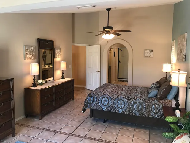 a bedroom with a bed and a chandelier