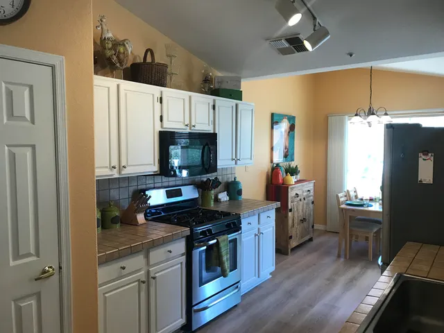 a kitchen with stainless steel appliances a sink stove and refrigerator