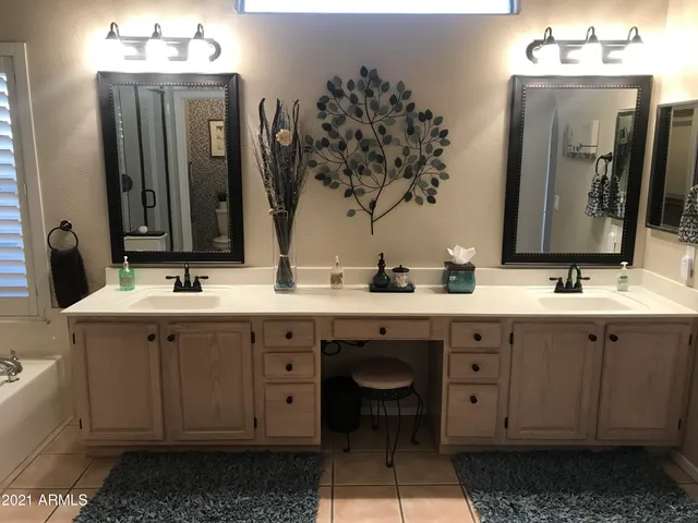 a bathroom with a double vanity sink mirror and