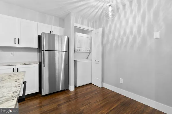a kitchen with stainless steel appliances granite countertop a refrigerator a stove and a sink