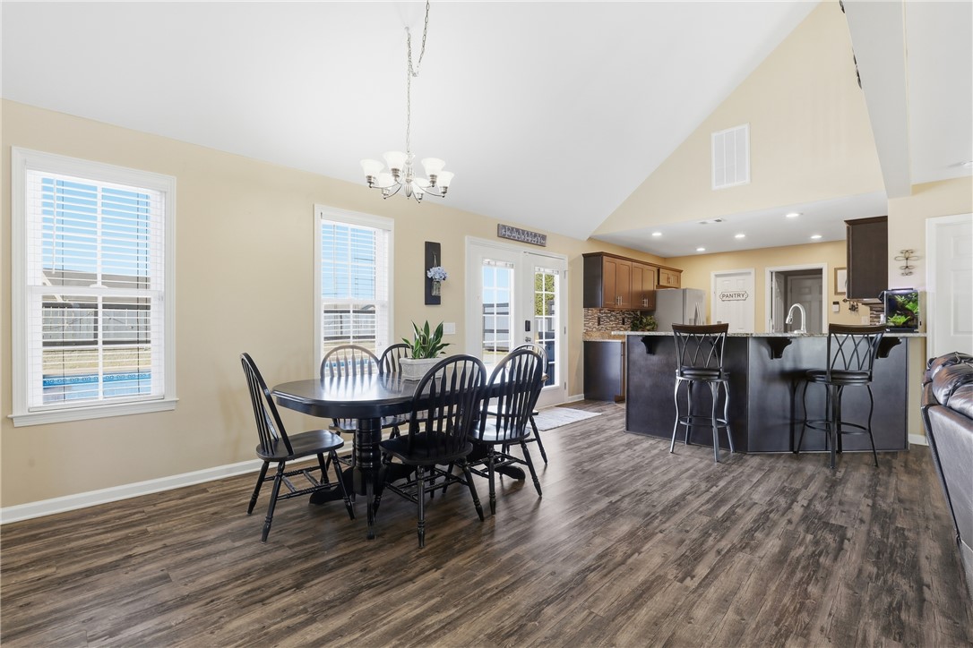 202 C-1-231 Pelzer, SC 29669 - Photo 10 of 49 This open concept dining and kitchen area features vaulted ceilings and hardwood flooring.