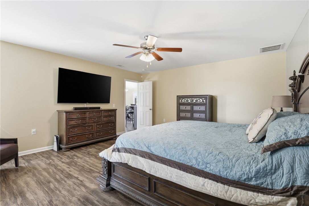 202 C-1-231 Pelzer, SC 29669 - Photo 15 of 49 This primary bedroom offers ample space, inviting comfort, and seamless access to adjacent living areas.