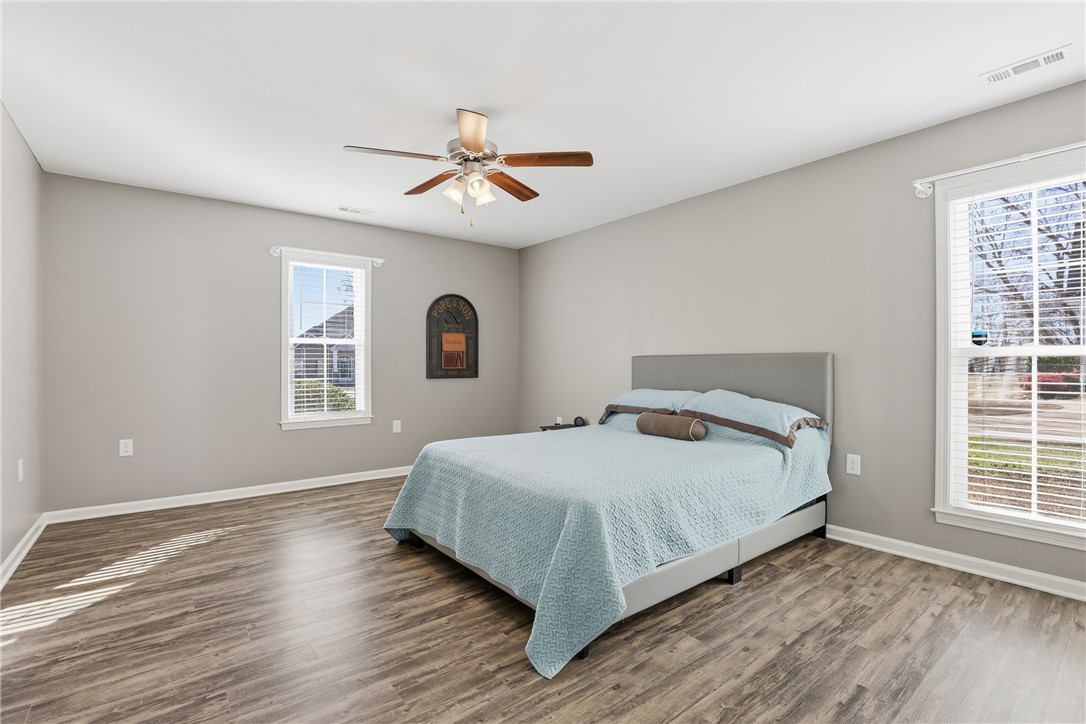 202 C-1-231 Pelzer, SC 29669 - Photo 19 of 49 This spacious bedroom features ample natural light and durable wood-look flooring.