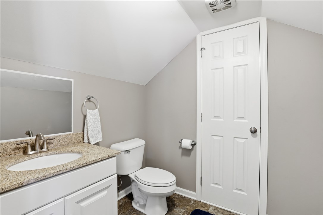 202 C-1-231 Pelzer, SC 29669 - Photo 25 of 49 This bathroom features a sleek vanity, mirror, and a toilet, perfect for any home.