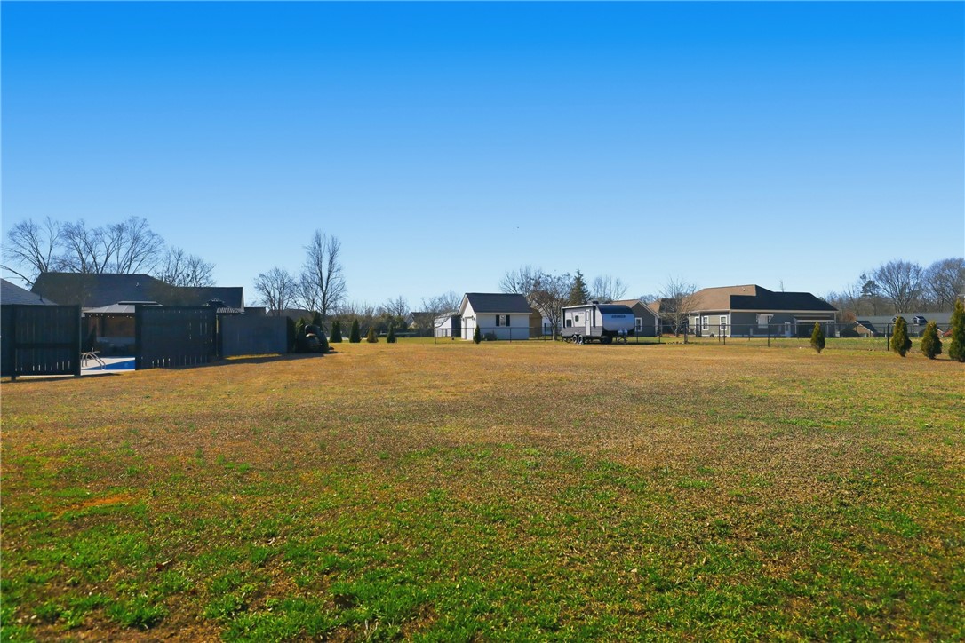 202 C-1-231 Pelzer, SC 29669 - Photo 32 of 49 Expansive outdoor space with a fenced-in pool and charming shed, perfect for leisure.