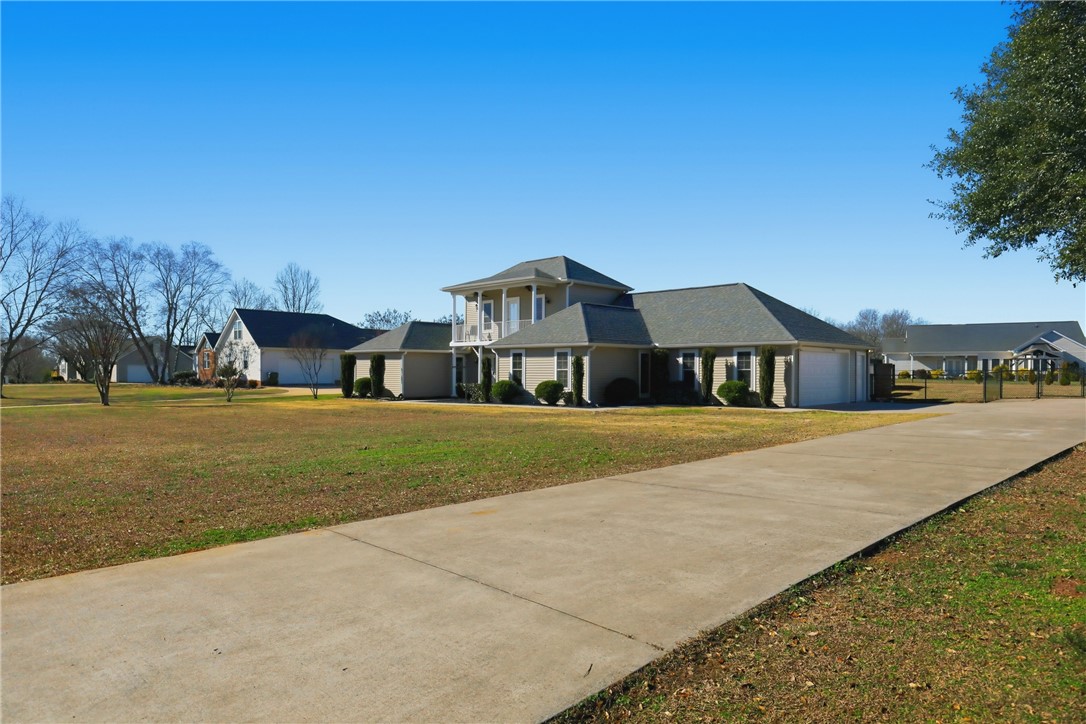 202 C-1-231 Pelzer, SC 29669 - Photo 36 of 49 This expansive home offers a grand entrance and a sprawling concrete driveway.