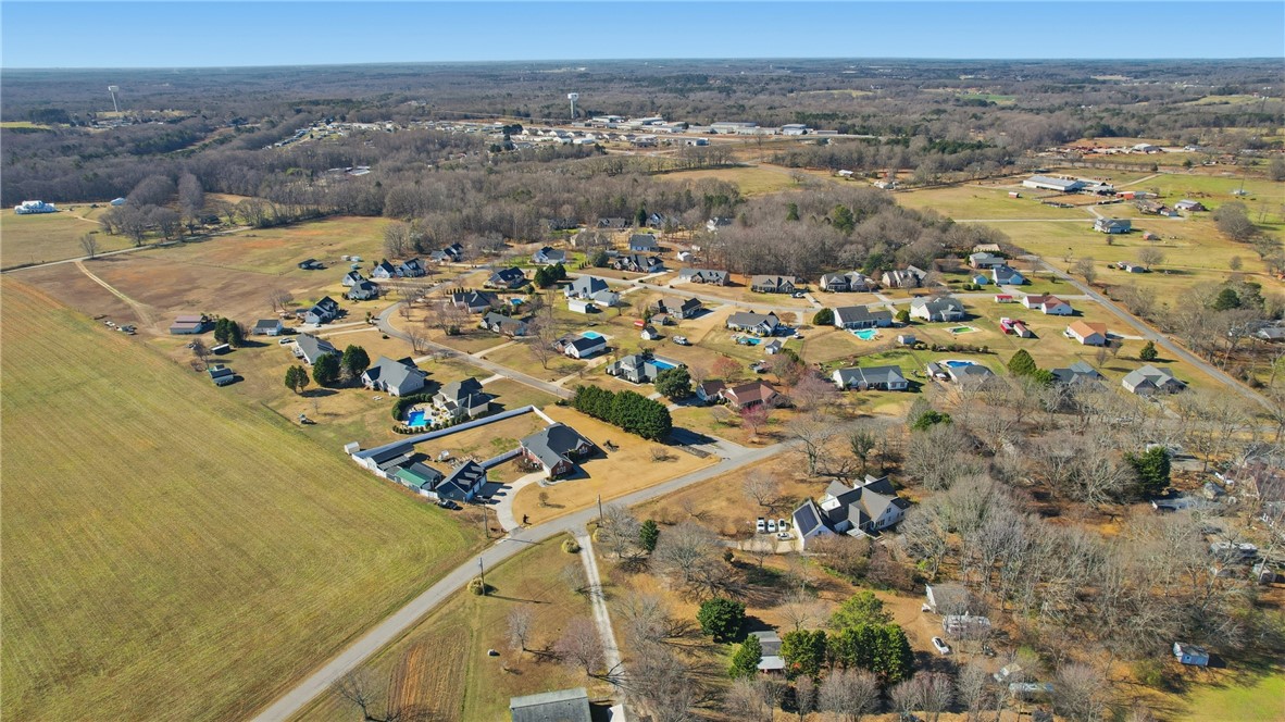 202 C-1-231 Pelzer, SC 29669 - Photo 40 of 49 An aerial perspective reveals a serene residential community nestled amidst expansive natural landscapes.