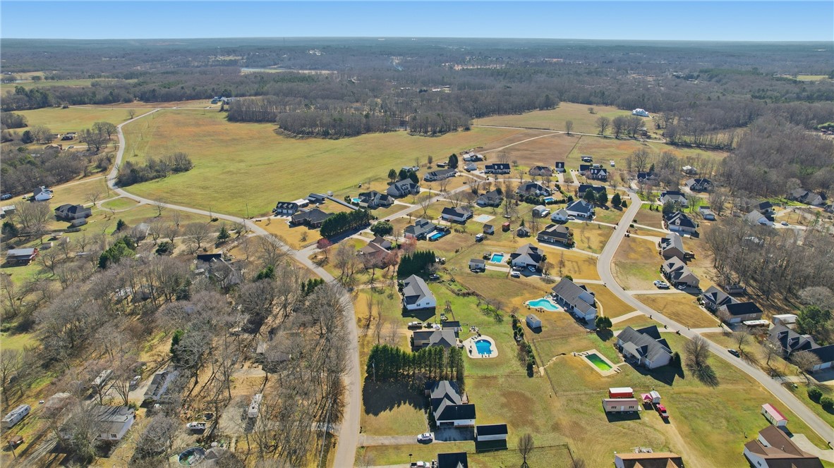 202 C-1-231 Pelzer, SC 29669 - Photo 41 of 49 An aerial perspective reveals a vibrant neighborhood with inviting pools and mature trees.