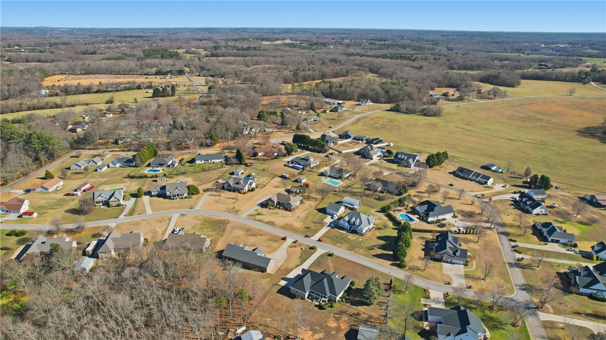 202 C-1-231 Pelzer, SC 29669 - Photo 42 of 49 This elevated view captures a serene neighborhood nestled amidst expansive fields and distant woodlands.
