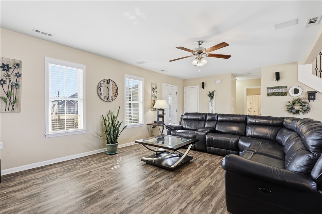 202 C-1-231 Pelzer, SC 29669 - Photo 5 of 49 This inviting living area features durable flooring and ample natural light, creating a comfortable ambiance.