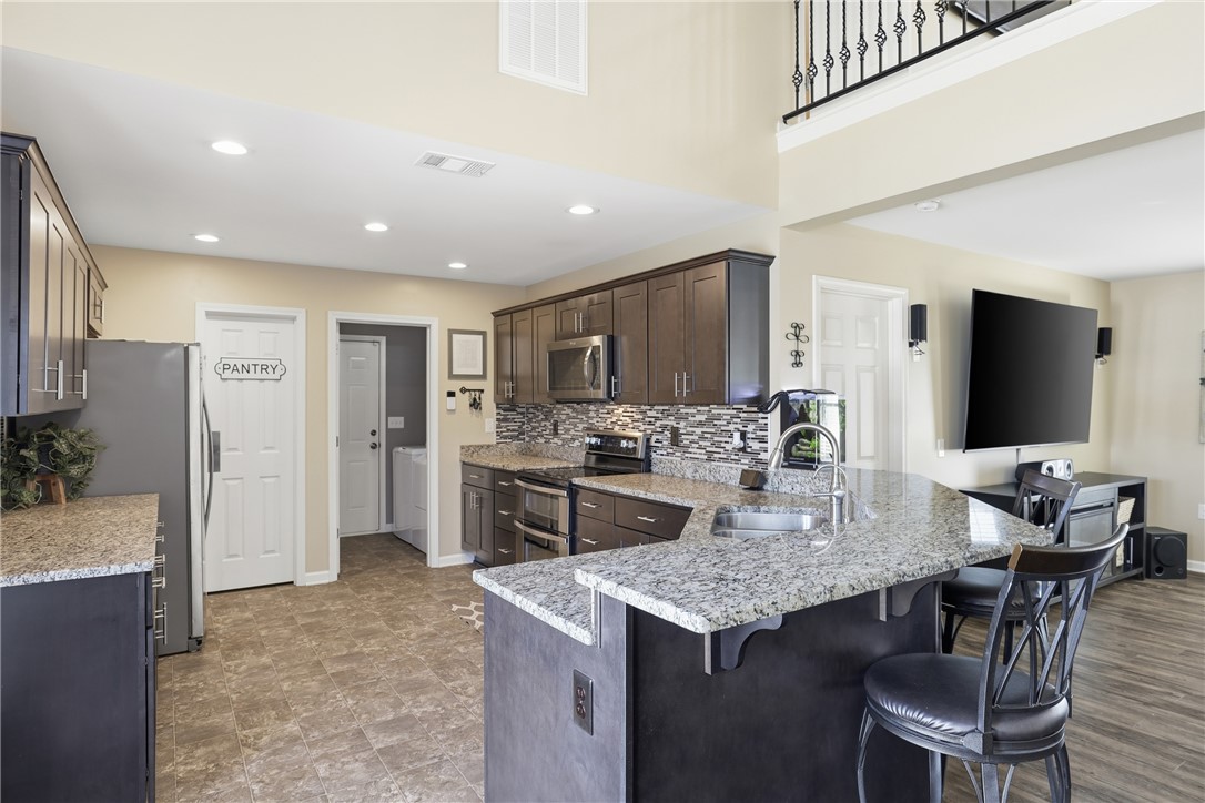 202 C-1-231 Pelzer, SC 29669 - Photo 8 of 49 This modern kitchen features elegant countertops, sleek cabinetry, and integrated appliances, perfect for entertaining.