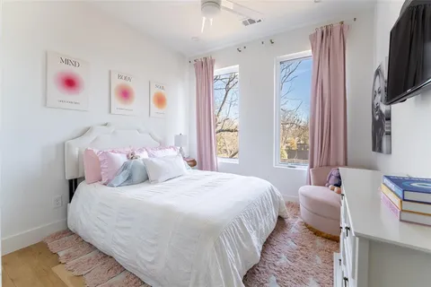 a bedroom with a bed and a flat screen tv