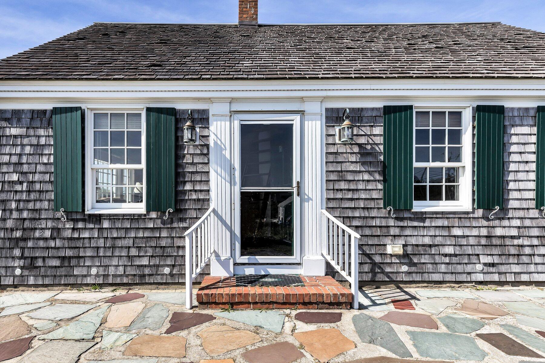 6 Bay View Path Truro, MA 02666 - Photo 11 of 57 a front view of a house with a brick wall