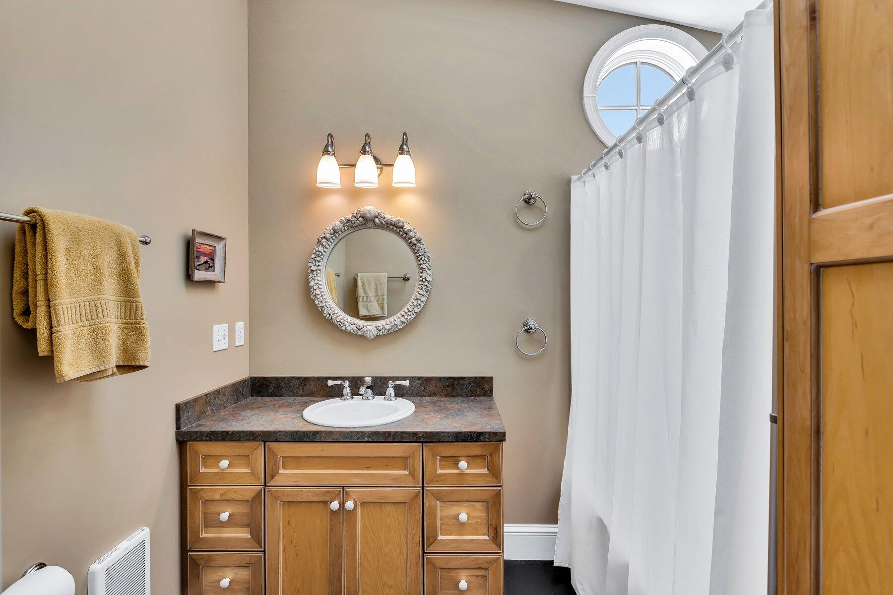 6 Bay View Path Truro, MA 02666 - Photo 21 of 57 a bathroom with a sink a mirror and a light fixture