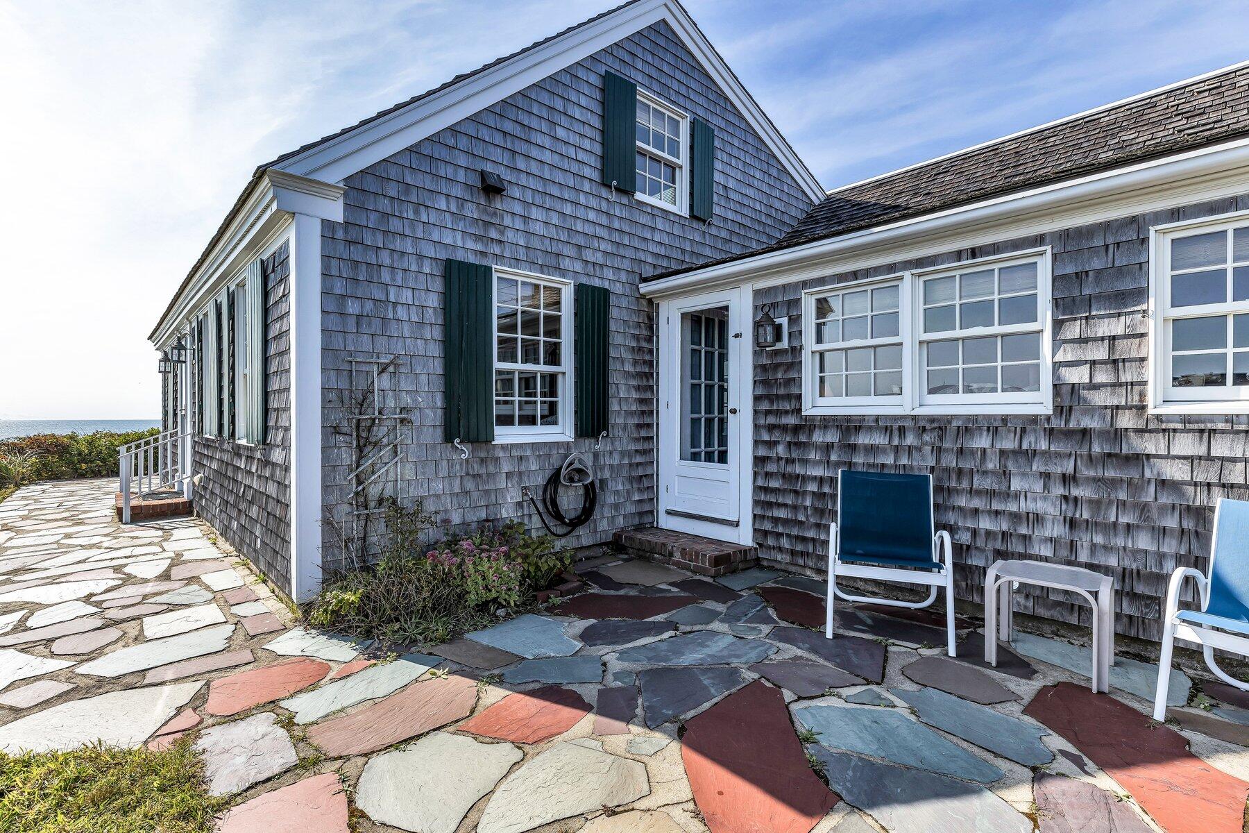 6 Bay View Path Truro, MA 02666 - Photo 10 of 57 a view of a porch with chairs and floor to ceiling window