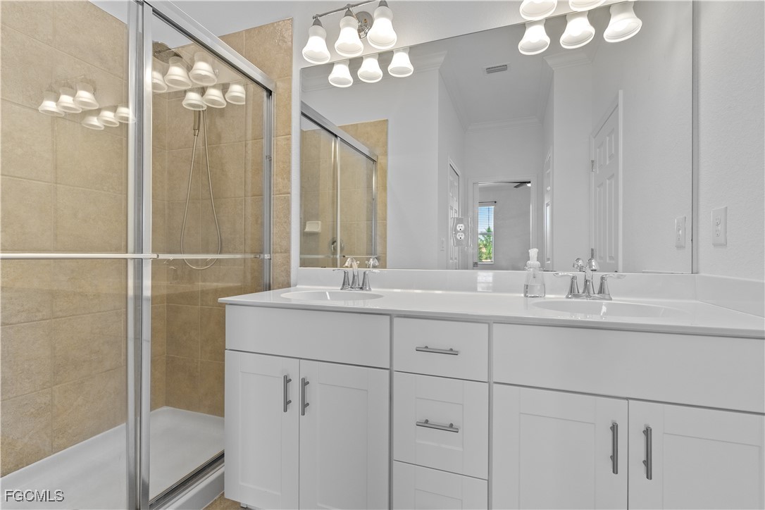 12557 Westhaven Way Fort Myers, FL 33913 - Photo 18 of 24 a bathroom with a sink vanity and a mirror
