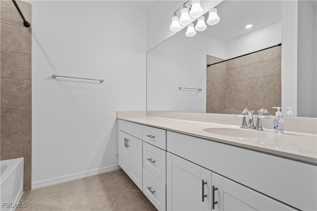 12557 Westhaven Way Fort Myers, FL 33913 - Photo 20 of 24 a bathroom with a double vanity sink and a mirror